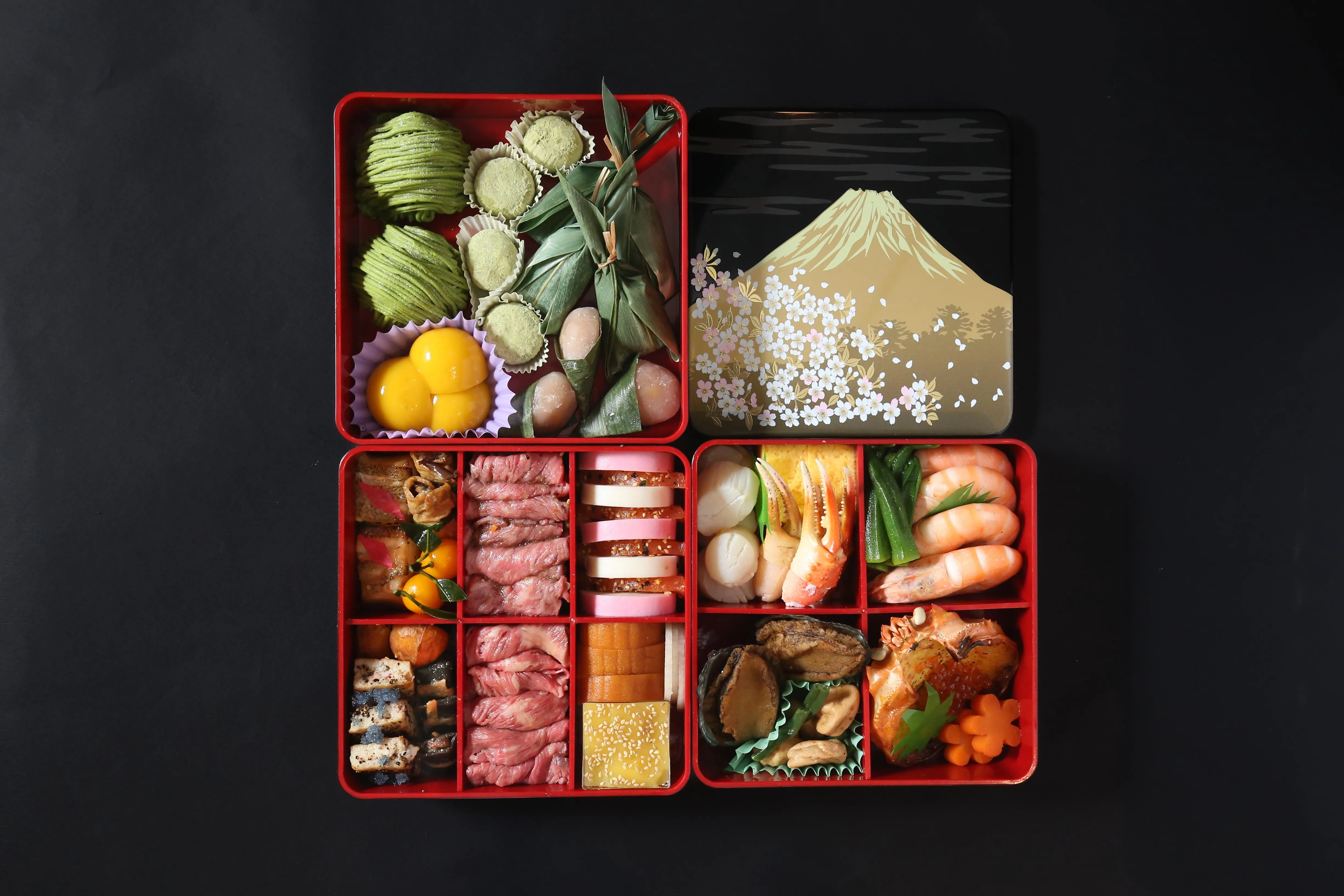 A meticulously arranged Osechi Ryori box for Japanese New Year, featuring various delicacies.