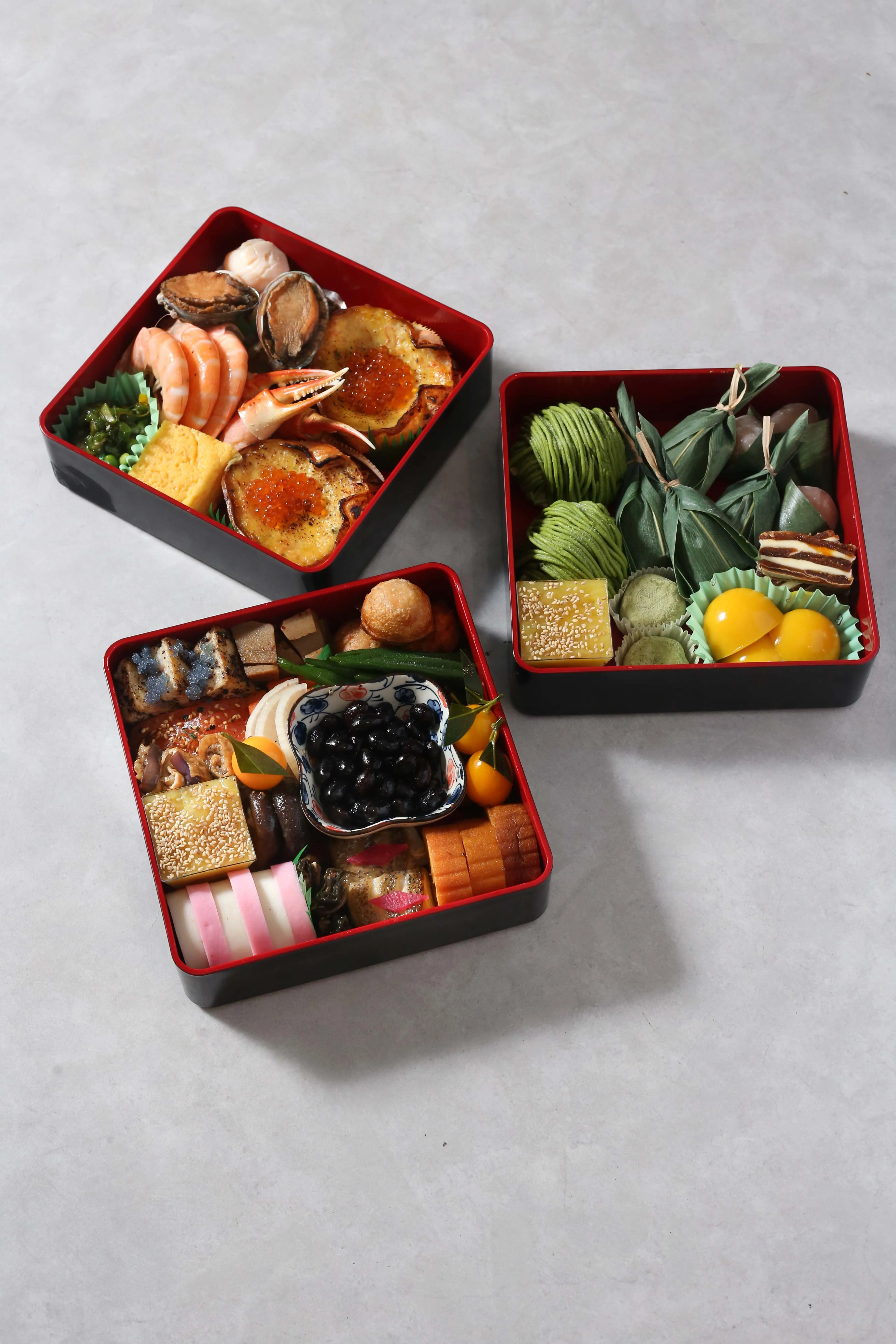 Three beautifully arranged Osechi boxes for Japanese New Year.
