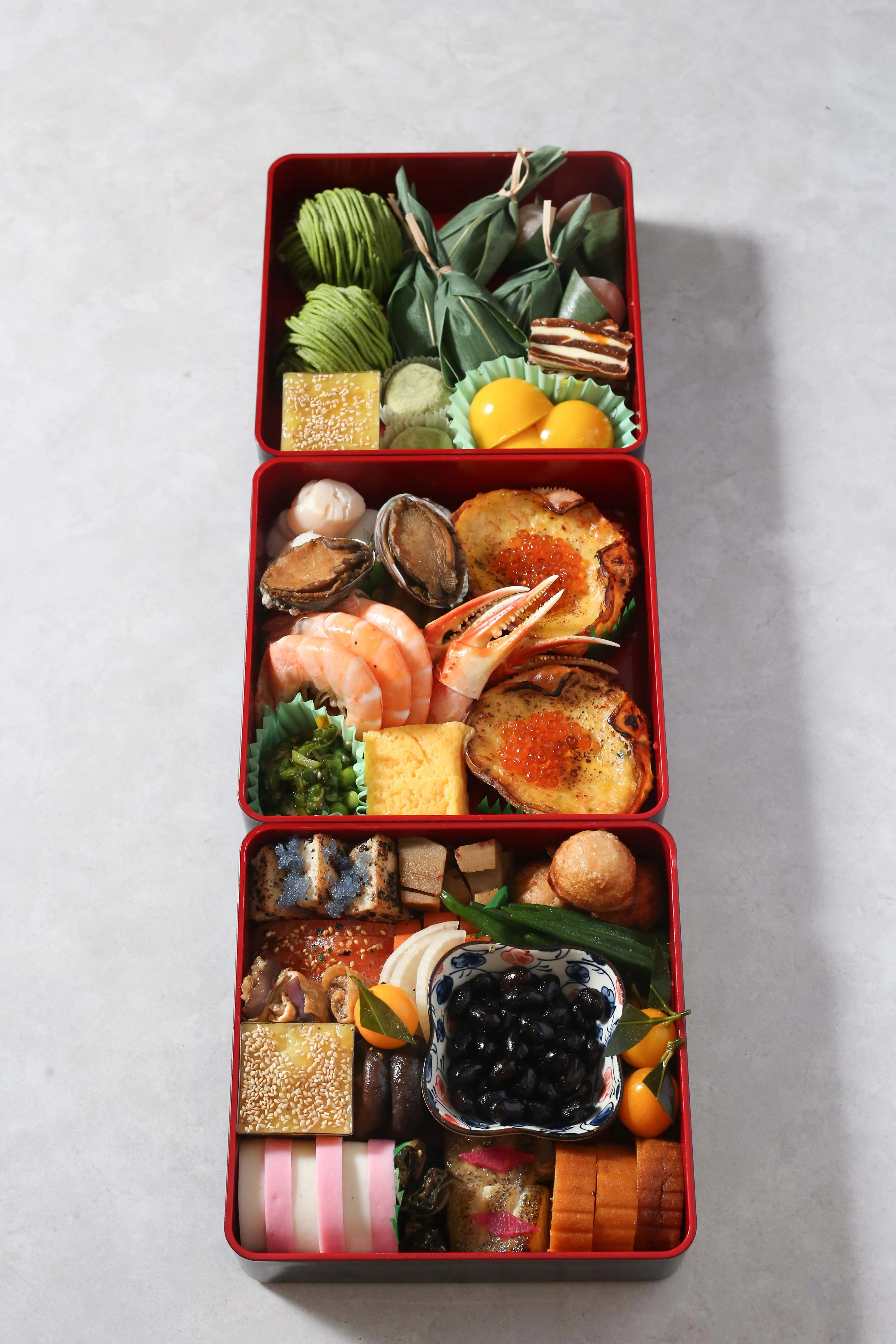 Traditional Japanese Osechi Ryori New Year's feast in red boxes.