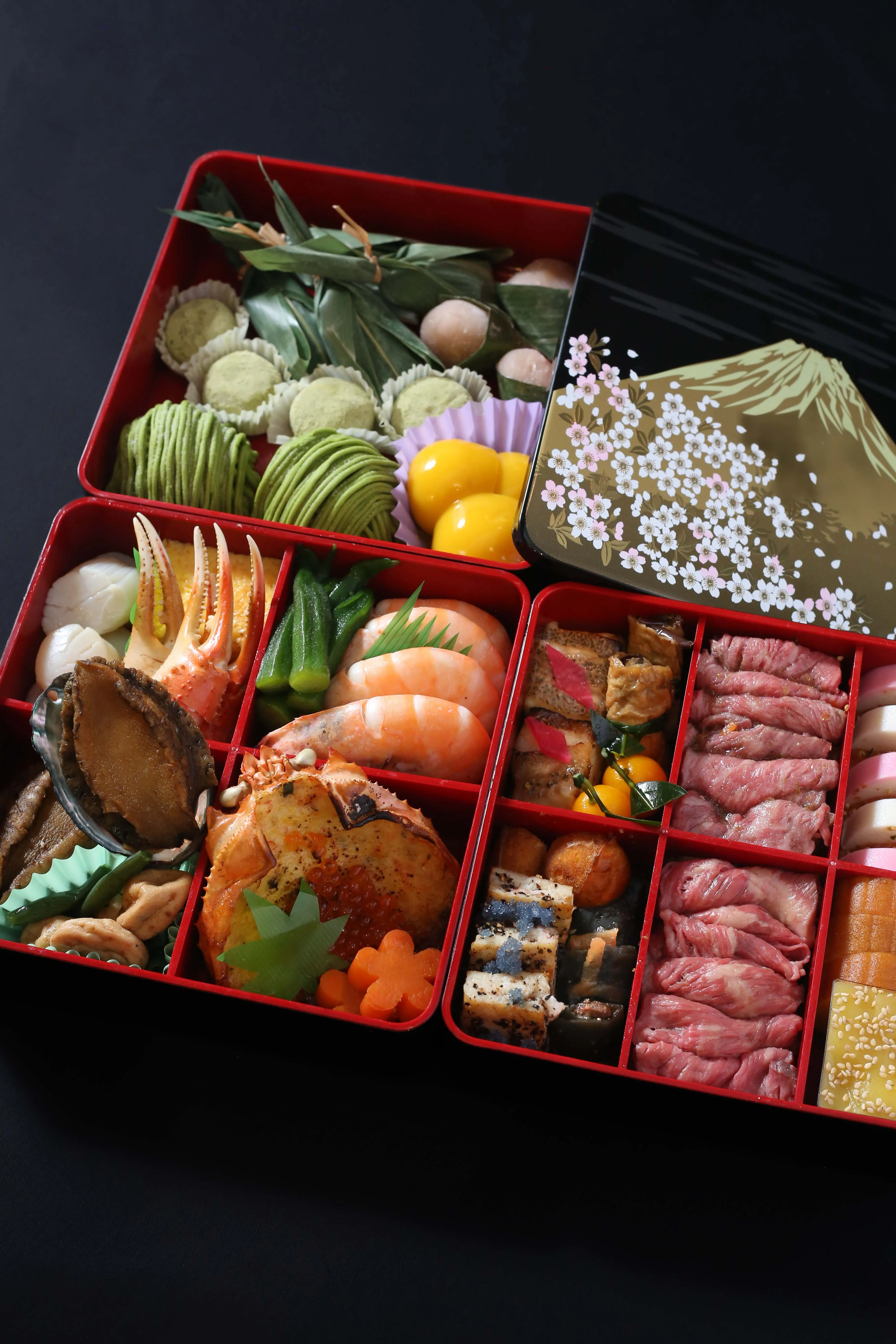 A luxurious Osechi Ryori feast in a red lacquer box.