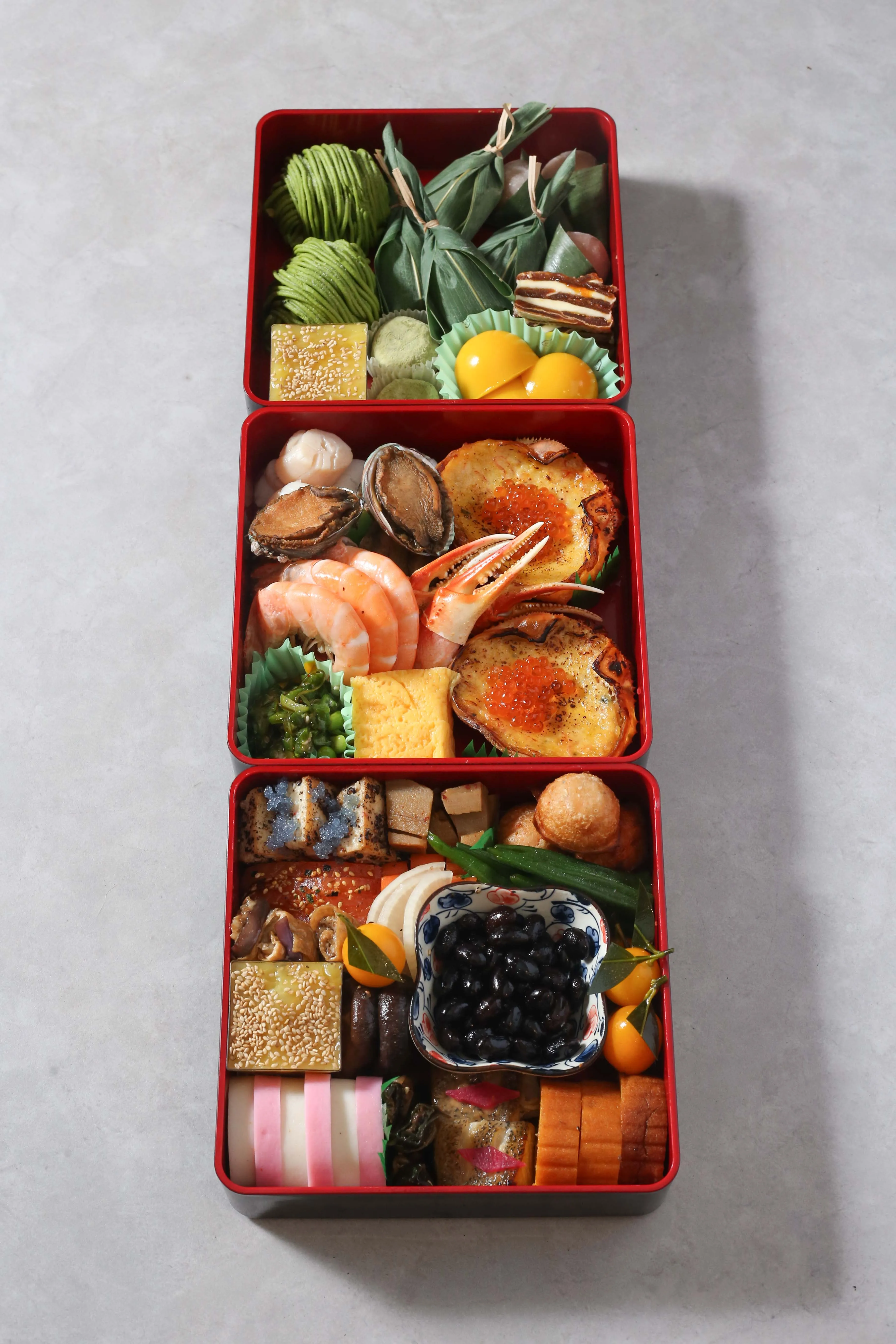 Three-tiered Osechi box filled with Japanese New Year delicacies.