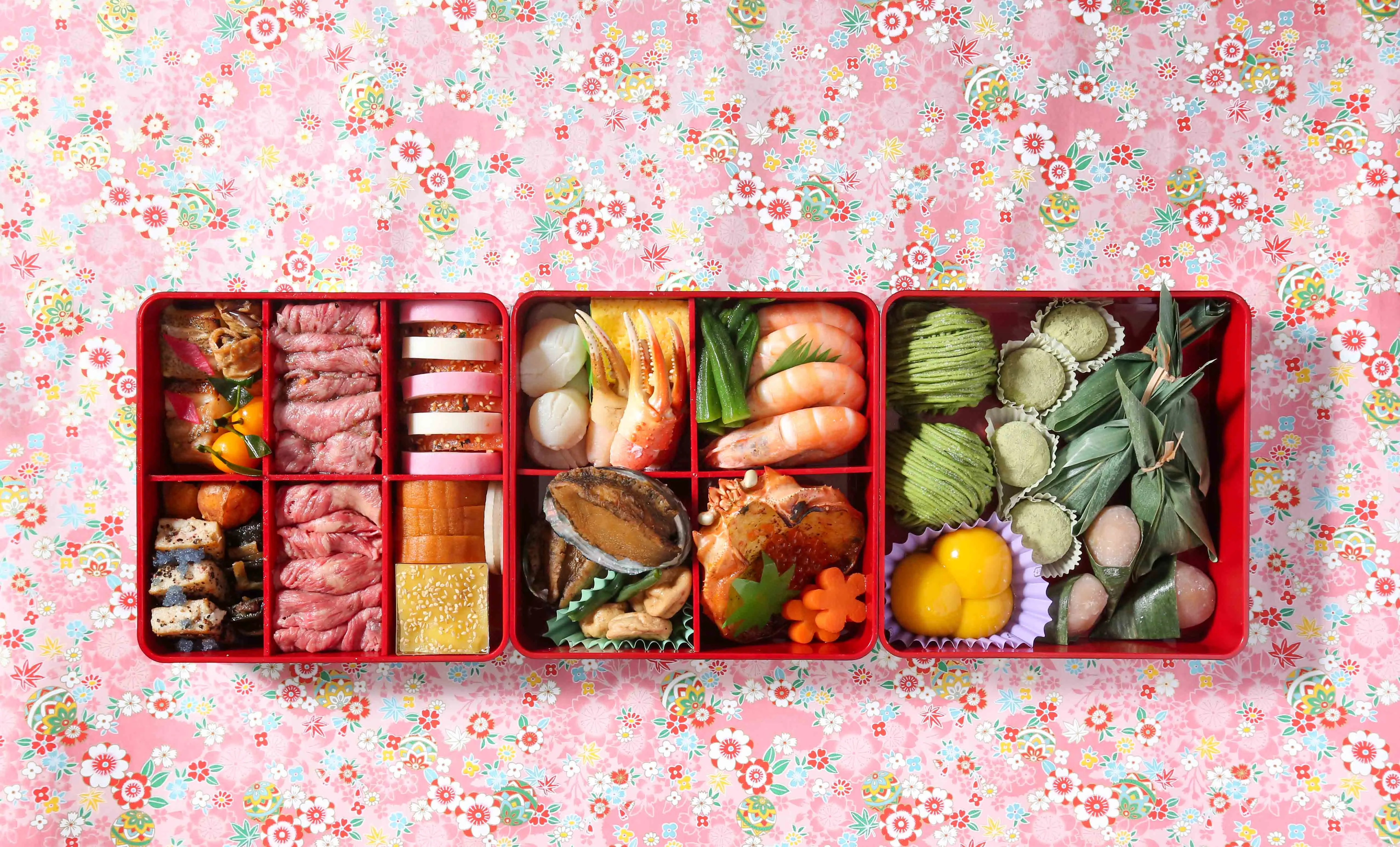 Overhead shot of a vibrant Osechi box filled with traditional Japanese New Year foods.